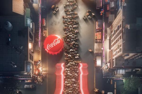 Happy to Queue — Coca-Cola overhead shot of crowd in a queue in the shape of a coca cola bottle. to the left of the queue is a large red coca cola bottle cap