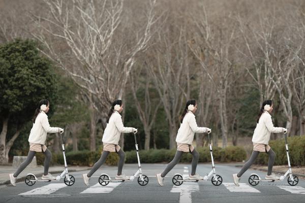 X4 - Volkswagen Four time Repeating image of a woman on a scooter crossing a street in a crosswalk