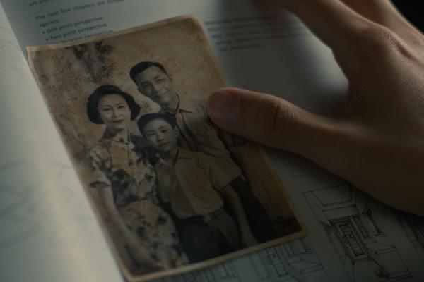 Legacy Lives On — HSBC Hand touching an old photograph of a father, mother and child