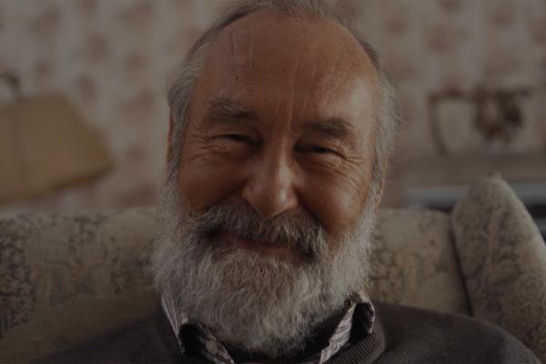 Let's Neighbor Up — Milka Elderly man with gray beard smiling