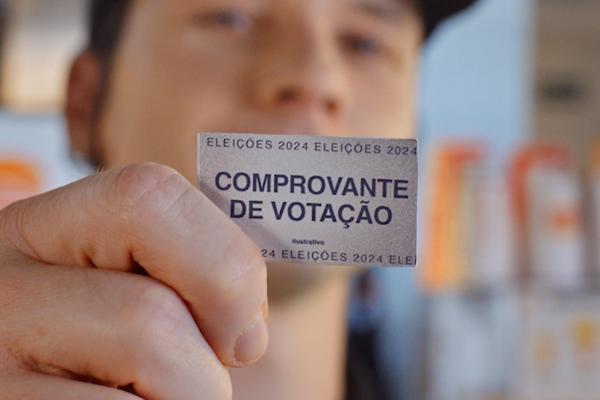 Burger King Wants to Buy Your Vote — Burger King Close up of a person holding a small receipt in front of their face. It says "Comprovante de Votação"