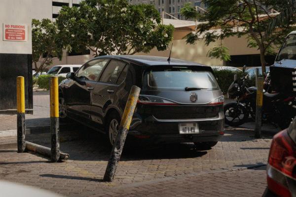 It's the Land Cruiser in you — Al-Futtaim Toyota Car parked in odd location, between black and yellow bollards