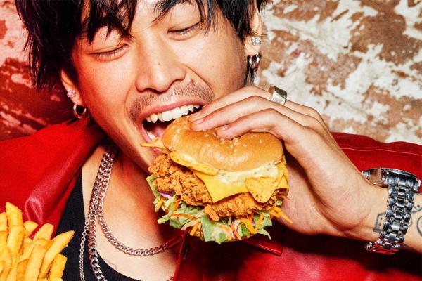 KFC FLG — KFC Young man happy as he brings KFC sandwich to his mouth