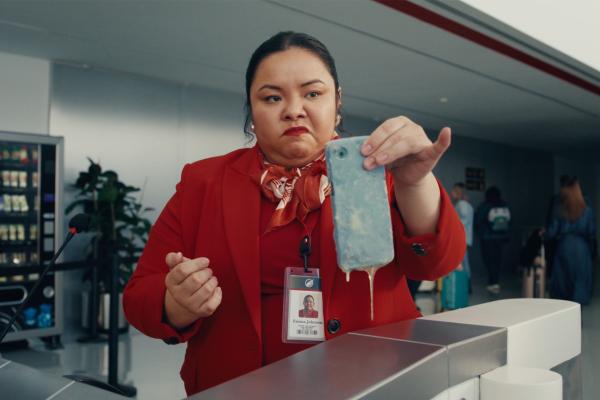 Boarding Pass — Verizon Airline staff at boarding area holding a phone that is dripping with an unknown substance