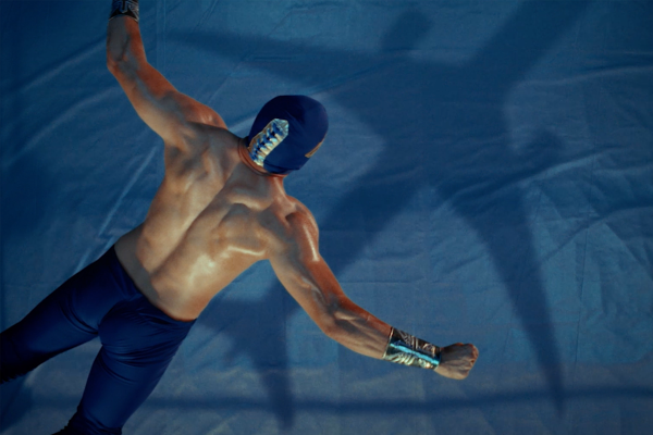 Aeromexico - Aeromexicaons Wrestler with arms spread open jumping into a wrestling ring