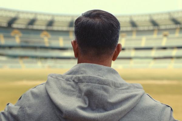 D For Dreams — Cadbury Bournvita Athlete standing in an empty stadium, wearing a gray hooded sweatshirt, filmed from behind