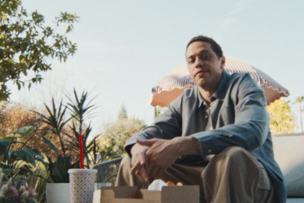 Pete Gets Serious With Verizon / Pete Locks It Down With Verizon — Verizon Pete Davidson sitting outside with a fast food meal on a table in front of him