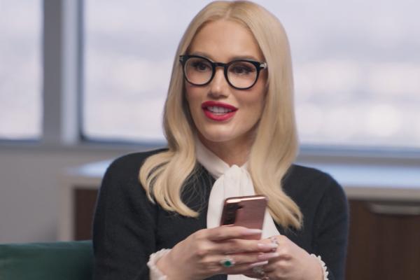 Carmen the Rock Star / Goodnight Rock Stars — Workday Gwen Stefani wearing business/corporate attire, holding a phone in her hands in an office setting