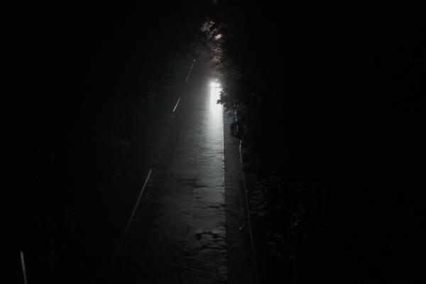 Night Signals — Chevrolet A dark road with a sliver of light down the middle