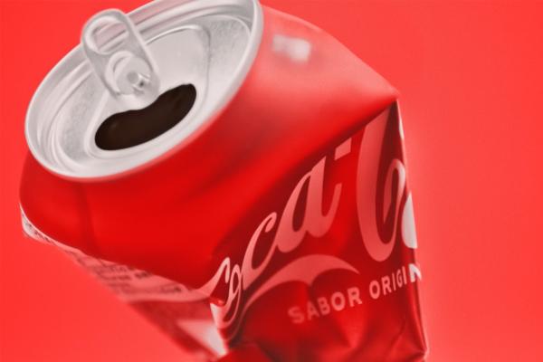 Recycle Me — Coca-Cola A crushed can of Coca-Cola against a red background