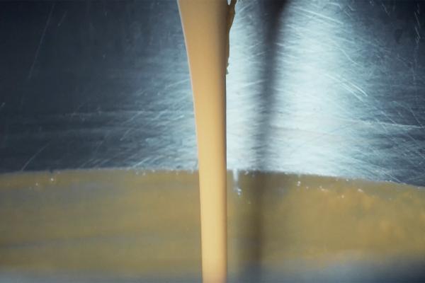 Self-Packing Cheese — Nestlé Liquid cheese being poured down into a steel vat