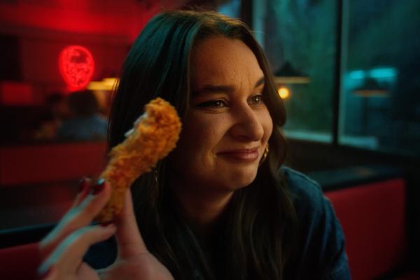The Flavour Has Spoken — KFC Young person holding KFC chicken and smiling