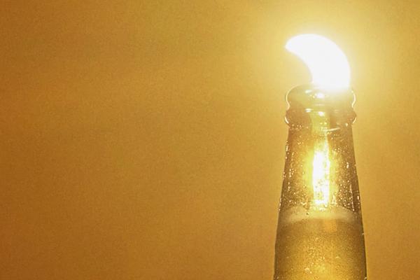 For Every Sunset — Corona Eclipse sun appearing as a lime wedge in a Corona bottle