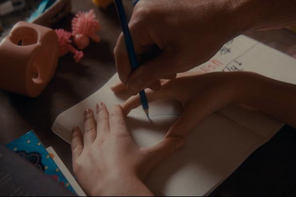 What They Wished For — Wallace Bishop Picture of child's hands making a circle while an adult hand draws inside the children's hands