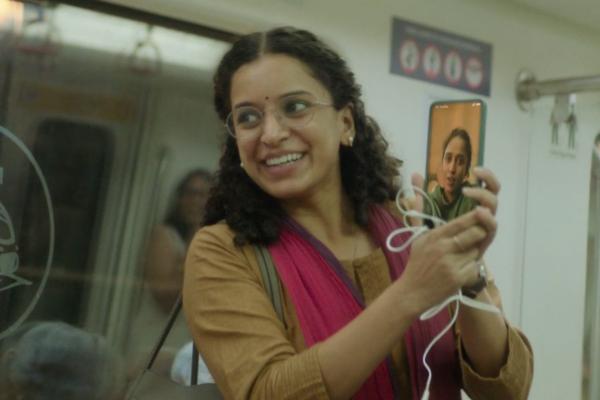 Be Someone's We — Vi Woman holding phone smiling while on a subway train
